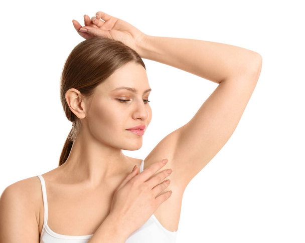 Young beautiful woman showing armpit with smooth clean skin on white background - Valokuva, kuva