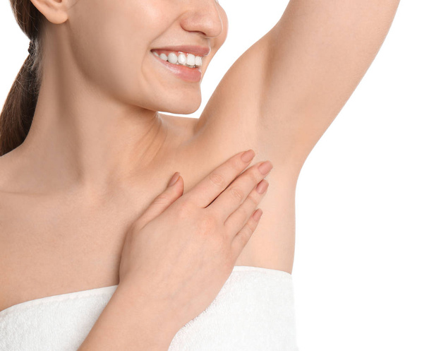 Young woman showing armpit with smooth clean skin on white background, closeup - Foto, afbeelding