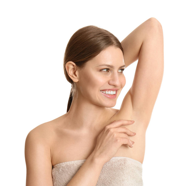 Young beautiful woman showing armpit with smooth clean skin on white background - 写真・画像