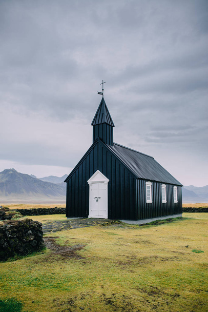 Icelandic landscape with a black church. - Zdjęcie, obraz