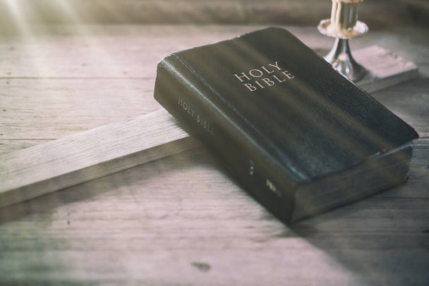 Biblia sobre tabla de madera de roble viejo con luz de ventana
 - Foto, Imagen