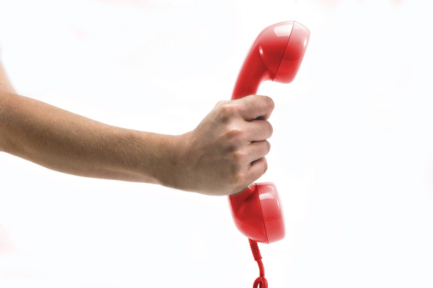 Piros telefon vevő a kezében - Fotó, kép