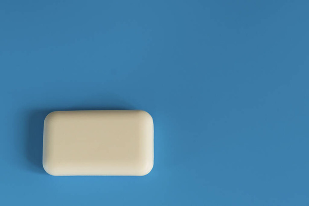Soap on a blue background. Hygiene and cleanliness. Bathroom accessories. Soap for bath, laundry and body care. Personal hygiene products - 写真・画像