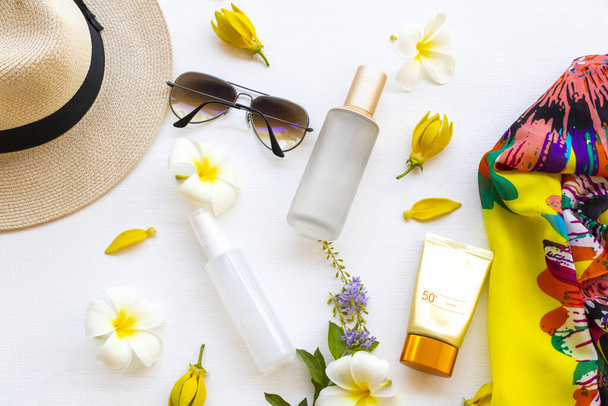 sunscreen spf50 ,collagen water spray ,toners serum therapy cosmetics health care for skin face with yellow scarf, sunglasses, and hat of lifestyle woman arrangement flat lay style on white  - Photo, Image