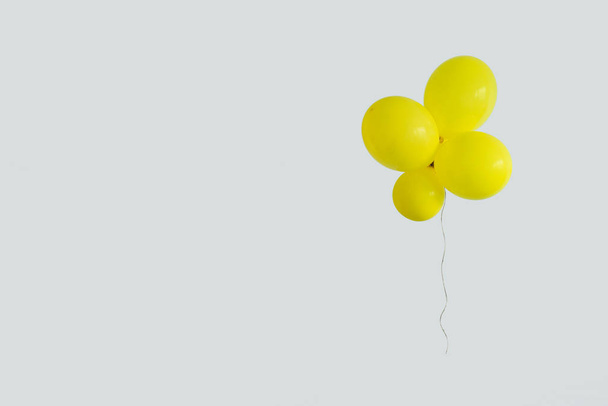 Set yellow balloon on white background with copy space. Minimal party concept - 写真・画像