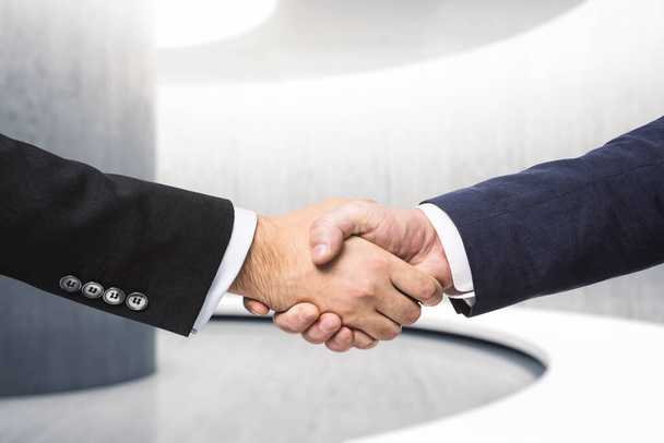 Two businessmen shake hands in the hallway, insider concept, close up - Foto, imagen