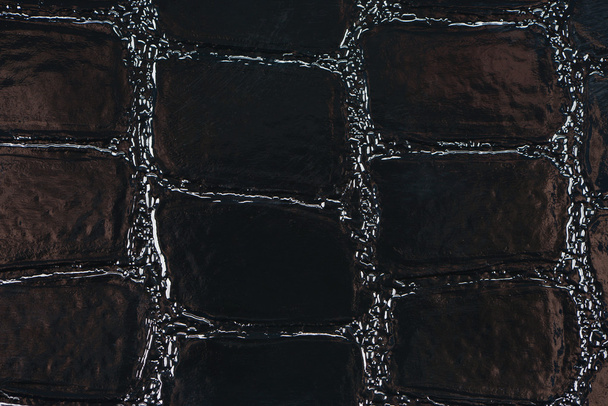 Black synthetic leather with embossed texture - Fotoğraf, Görsel