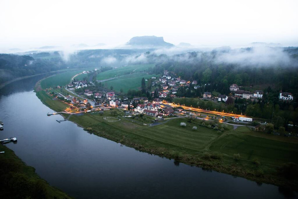 The charming town of Rathen in Saxony, Germany seen from Basteigebiet at dusk - Photo, Image