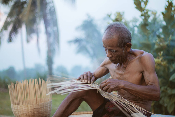 Old man are weaving basket of Thailand. - Photo, Image