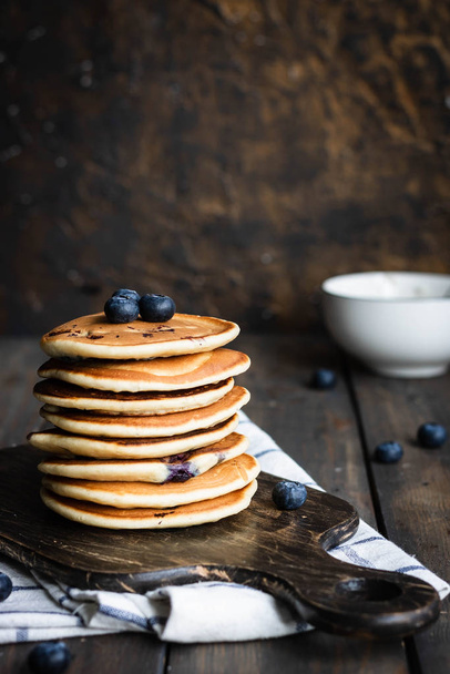 ricotta pancakes with blueberries on a dark wooden background - Foto, imagen
