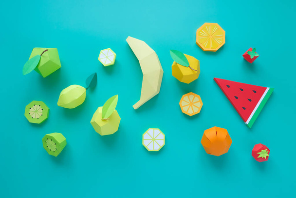 Different exotic fruits made of paper on trendy mint background - Valokuva, kuva