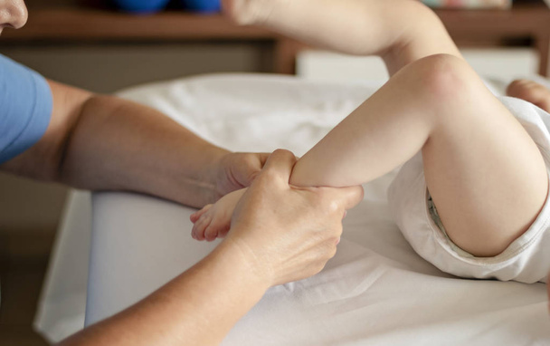 Bebê fazendo massagem nos pés em um centro de reabilitação
. - Foto, Imagem