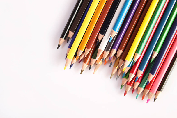 Colored pencils lie in a row - Фото, изображение