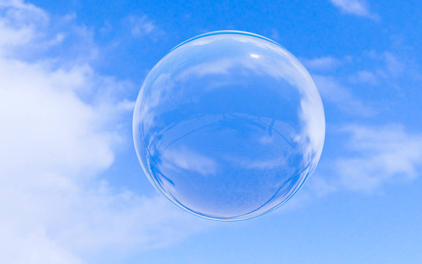 Bubble soap on blue sky with clouds background texture in bright morning. 3d ball, round circle. Transparent glass sphere for clean atmosphere. Nature abstract white cloudscape in sunny day. - 写真・画像