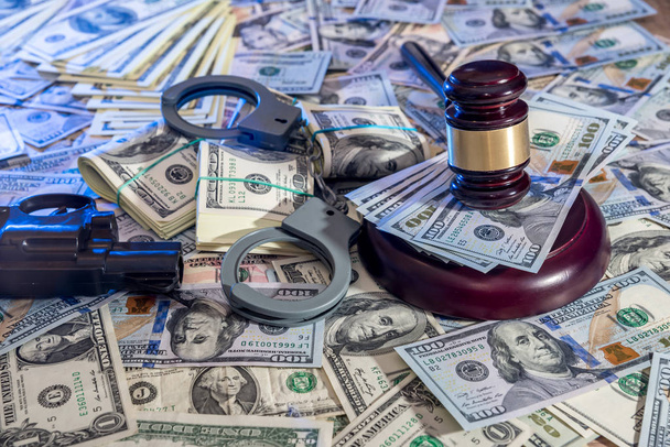 Judge gavel with money and handcuffs, gun. - Photo, Image