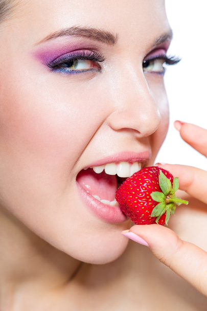 Nahaufnahme einer Frau, die Erdbeere isst - Foto, Bild