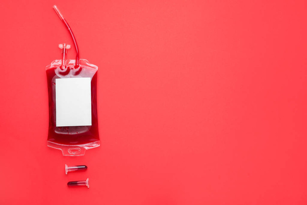 Blood pack for transfusion and test tubes on color background - Foto, Imagen