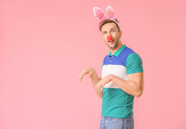 Man in funny disguise on color background. April fools' day celebration - Zdjęcie, obraz