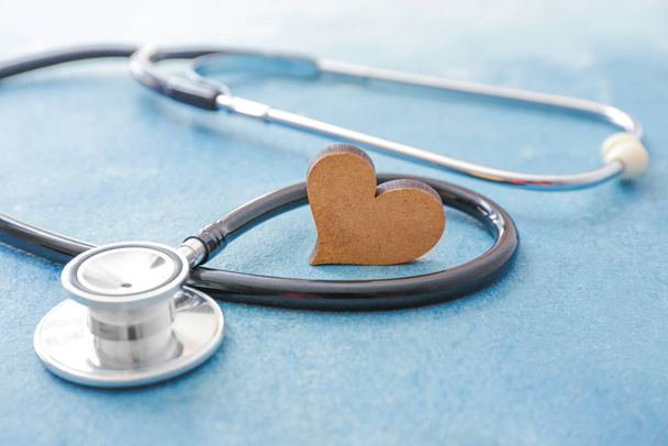 Stethoscoop en hart op kleur achtergrond. Cardiologie - Foto, afbeelding