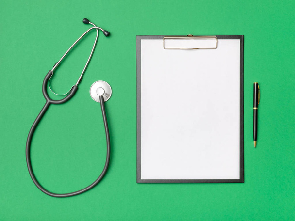 Workplace of doctor with notebook and stethoscope - Foto, imagen