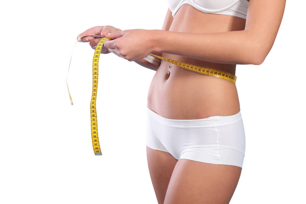 Woman measuring her slim body - Fotografie, Obrázek