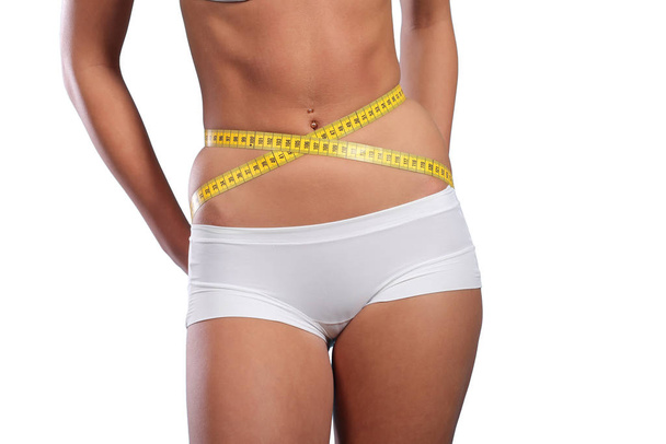 Mulher medindo seu corpo magro
 - Foto, Imagem