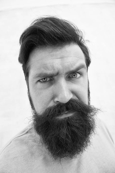 Strict face. Beard fashion barber. Handsome guy. Masculinity concept. Suspicious look. Man bearded hipster stylish beard grey background. Perceptions of male beauty. Stylish beard and mustache care - Fotoğraf, Görsel