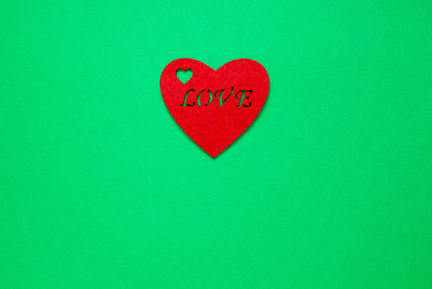 Decorative heart with the inscription love on a green background - Foto, immagini