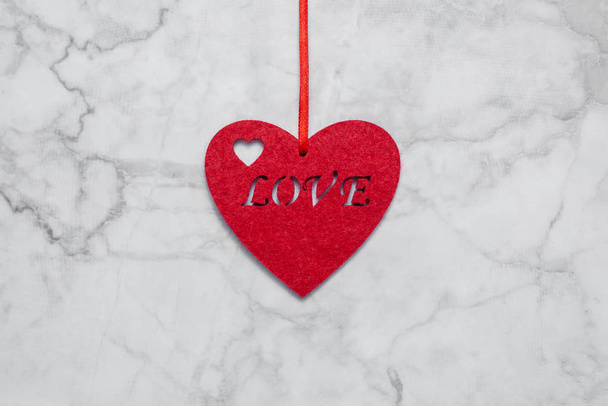 Decorative heart with the inscription love on a white marble background - Foto, Imagen