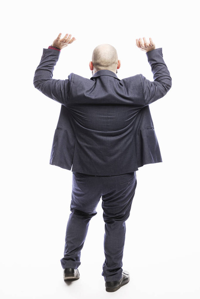A bald man stands with his back raised up. White background. Full height.  - Fotó, kép