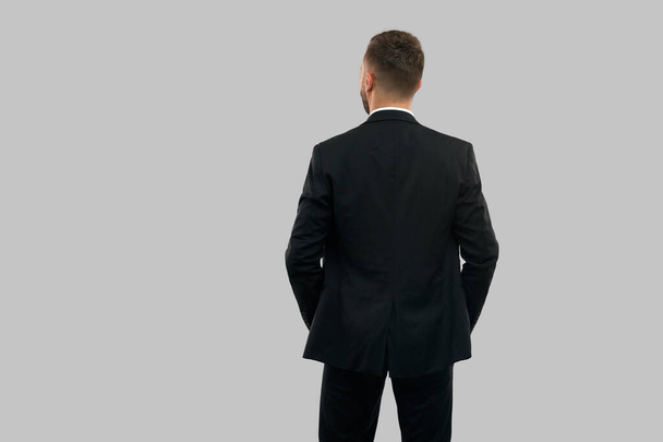 Back view of businessman with hands in pockets. - Foto, Imagen