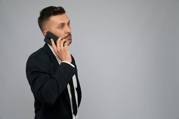 Serious businessman talking on phone. - Valokuva, kuva
