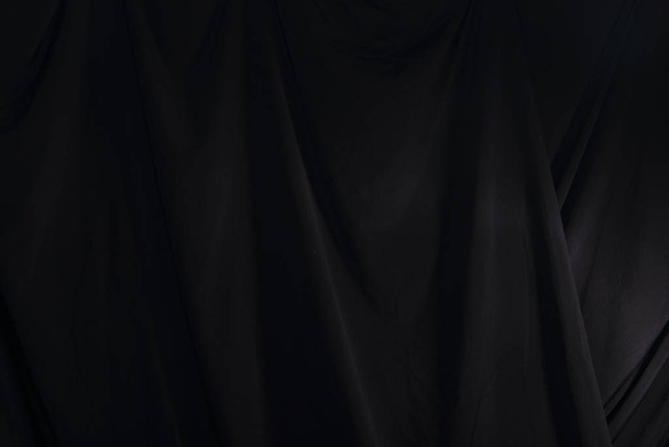 Black Curtain drape wave with studio lighting - Photo, Image