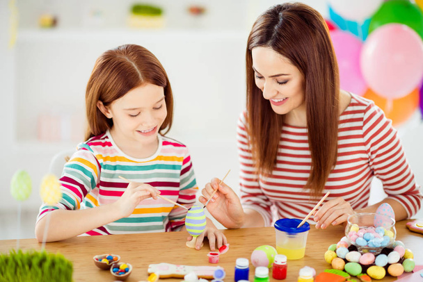 Close-up portrait of nice attractive lovely winsome cheerful cheery girls small little daughter creating handicraft handiwork in white light interior room house indoors - 写真・画像