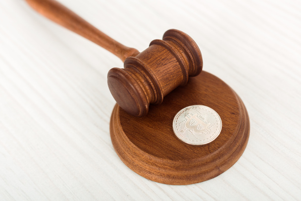 high angle view of wooden gavel and silver coin on table  - Photo, Image