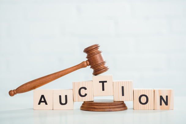 gavel and wooden cubes with auction lettering on white background  - Photo, Image