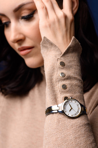 Close up portrait of middle age beautiful fashionable woman posing. Model wearing wrist watch. Female fashion concept - Fotó, kép