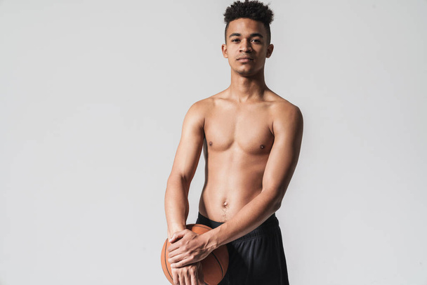 Portrait of shirtless african american man working out with basketball - Foto, Imagen