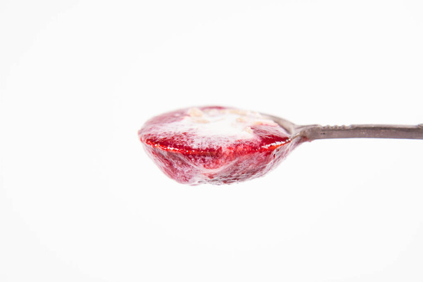 Beetroot cream soup, with yoghurt and sunflower seeds mixed in, on a vintage spoon - Fotoğraf, Görsel