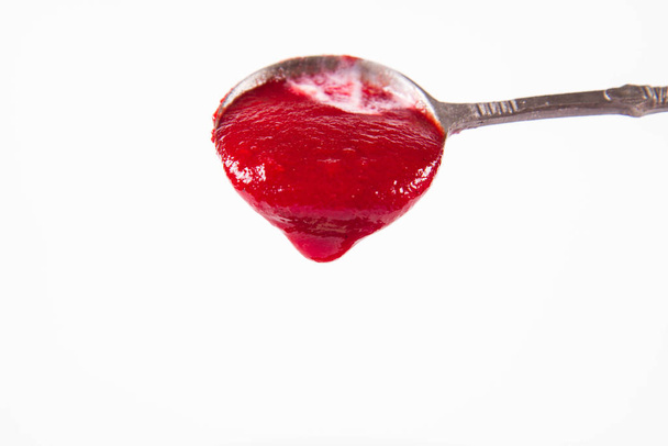 Beetroot cream soup, with yoghurt and sunflower seeds mixed in, on a vintage spoon - Photo, image