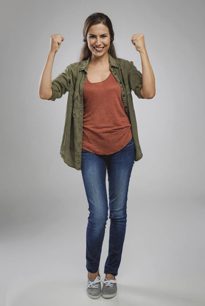 Successful young woman with arms raised - Φωτογραφία, εικόνα