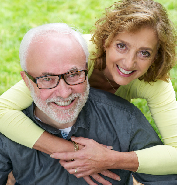 Portrait of a senior couple smiling together outdoors - Photo, Image