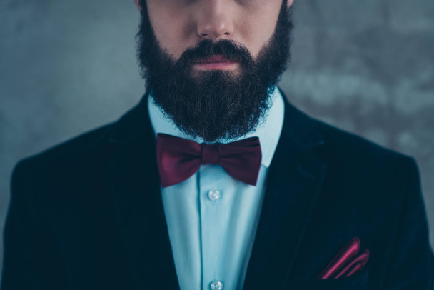 Cropped close-up view portrait of his he nice attractive well-dressed groomed serious bearded guy wearing velvet tux isolated over gray concrete industrial wall background - Фото, зображення
