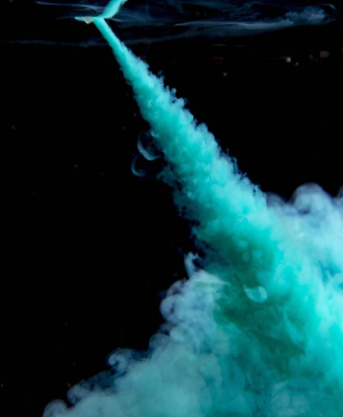 Abstract concept of teal color ink drop plume in water on an isolated  black background - Foto, immagini