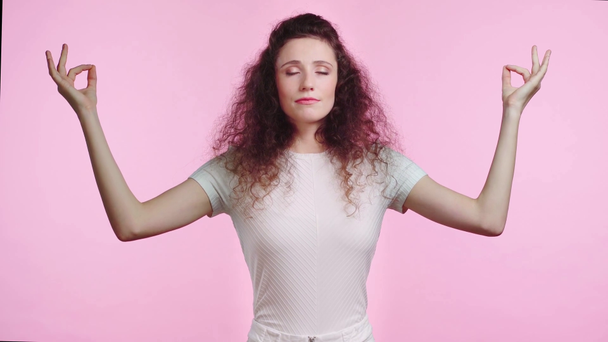 relaxed woman meditating isolated on pink  - Footage, Video