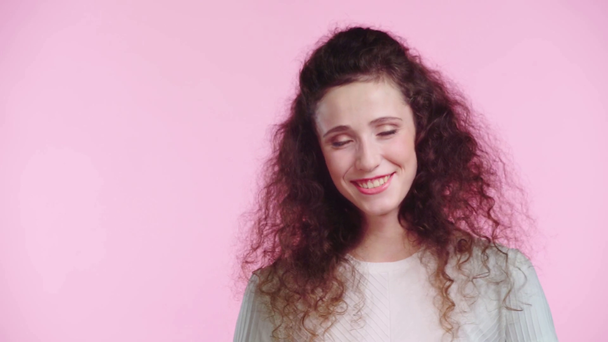 woman smiling at camera isolated on pink - Materiał filmowy, wideo