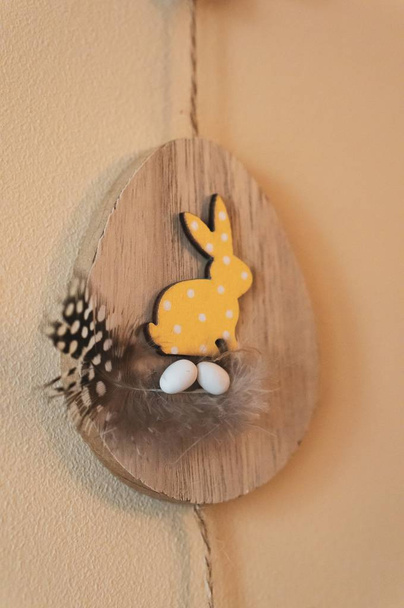 Wooden decoration of a rabbit hanging from the wall for Easter - Фото, изображение