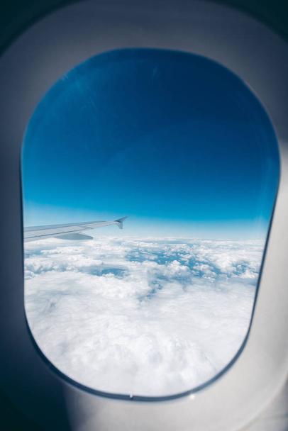 Airplane porthole window during flight - Fotoğraf, Görsel