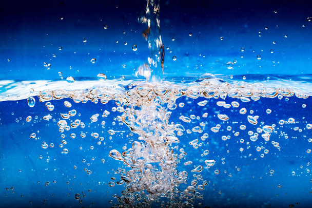 Water flowing, bubbles in water and under the water - Photo, Image