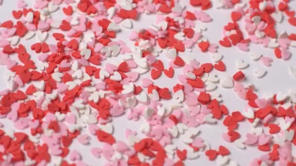 A lot of little hearts rotate on a white background. - Footage, Video